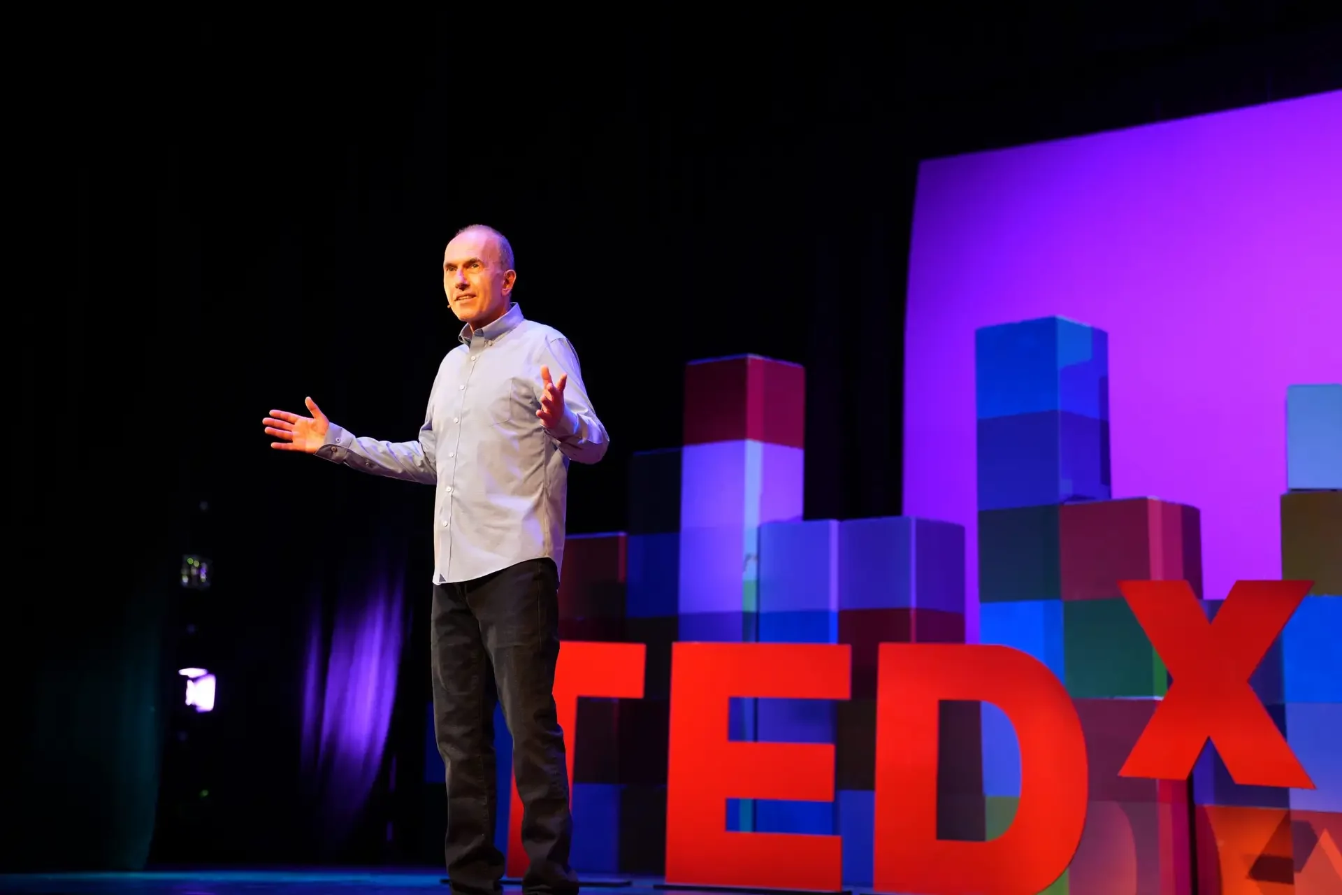 man speaking at ted talk