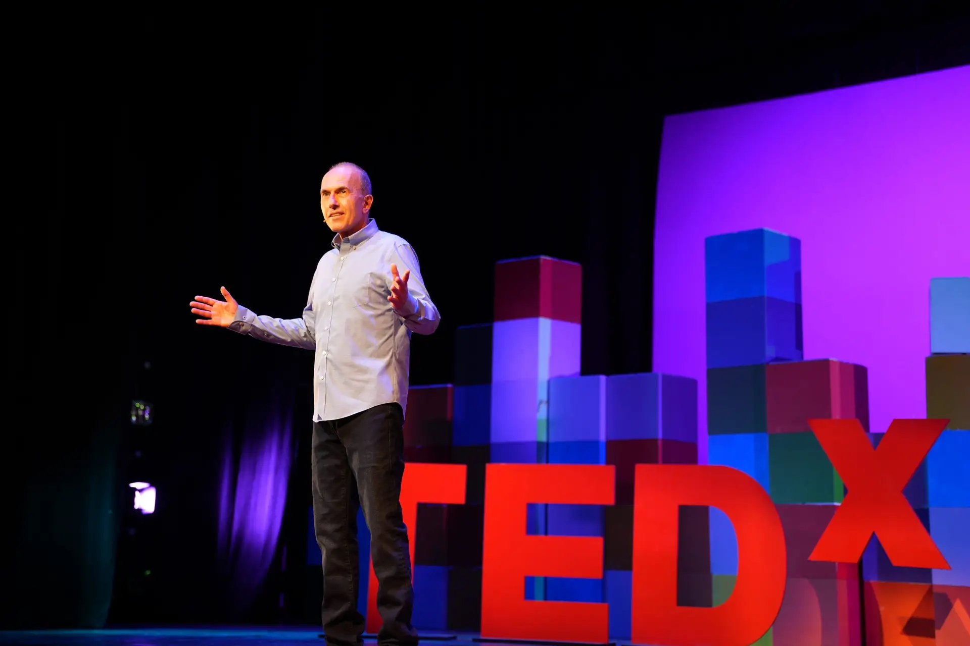 man speaking at ted talk