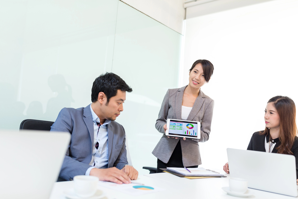 people coaching at whiteboard