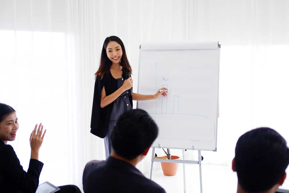 woman coaching at whiteboard