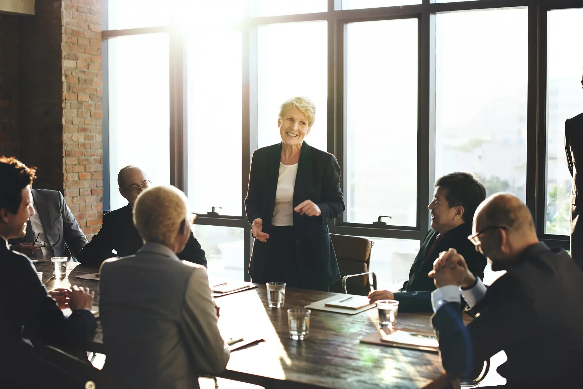 Business woman standing up at a corporate meeting
