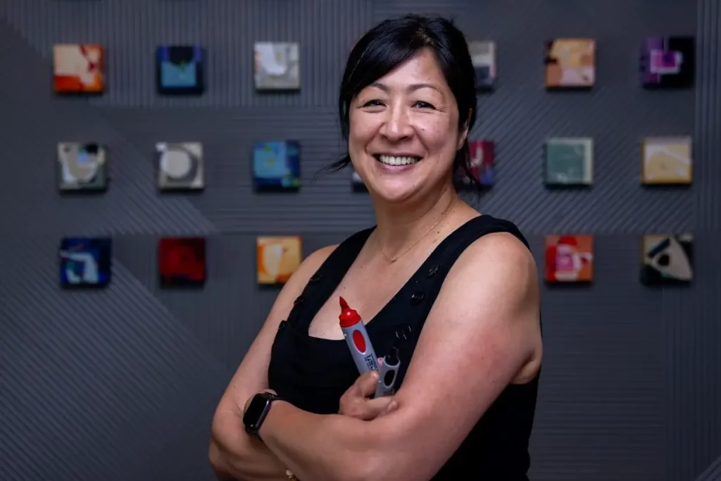 Executive Coach Summer Koide stands with arms crossed