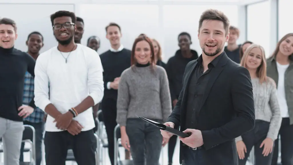 business coaching at company with group of people standing and smiling