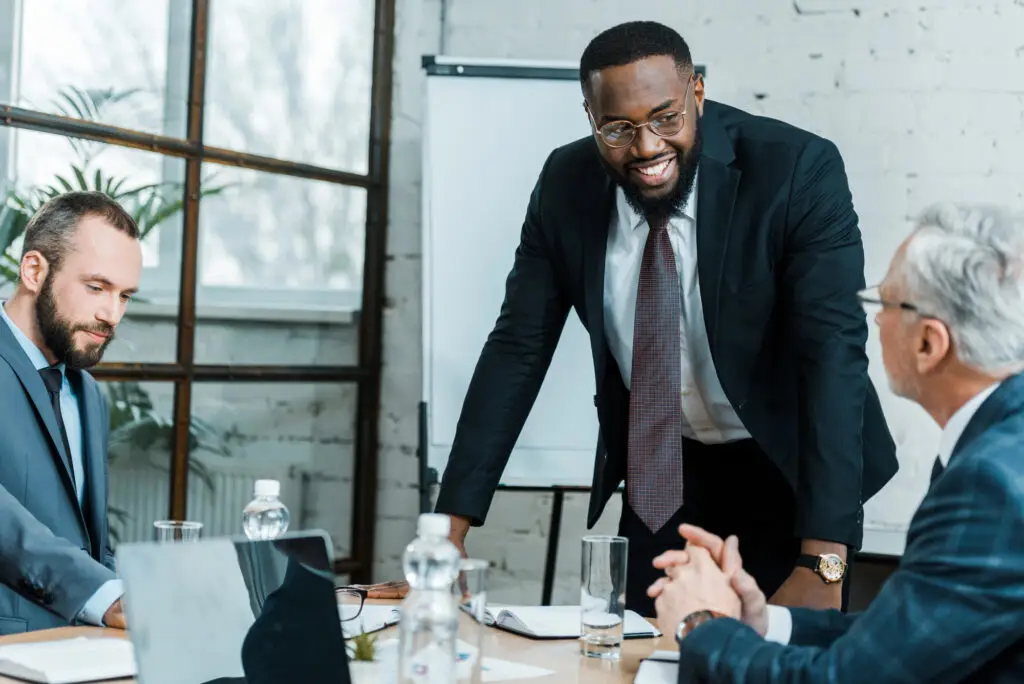 business people sitting at table coaching