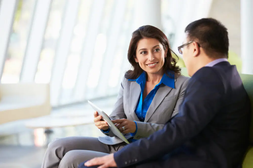 two business people sitting and talking
