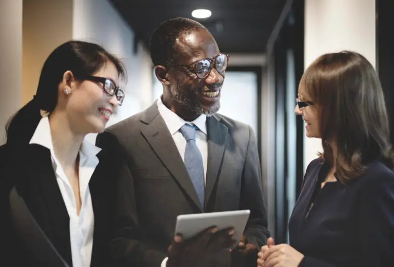 three business corporate people talking in hallway