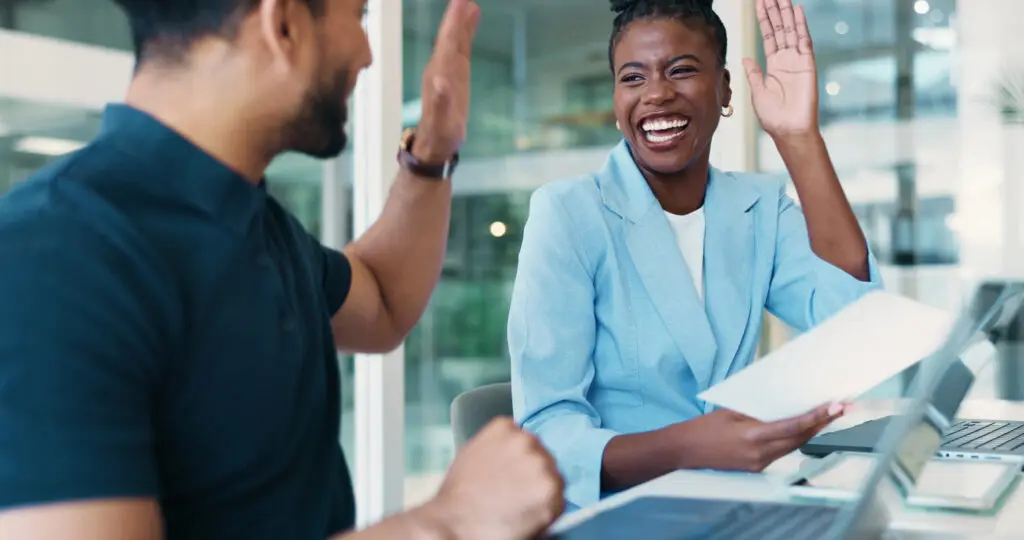 two people meeting giving a high five