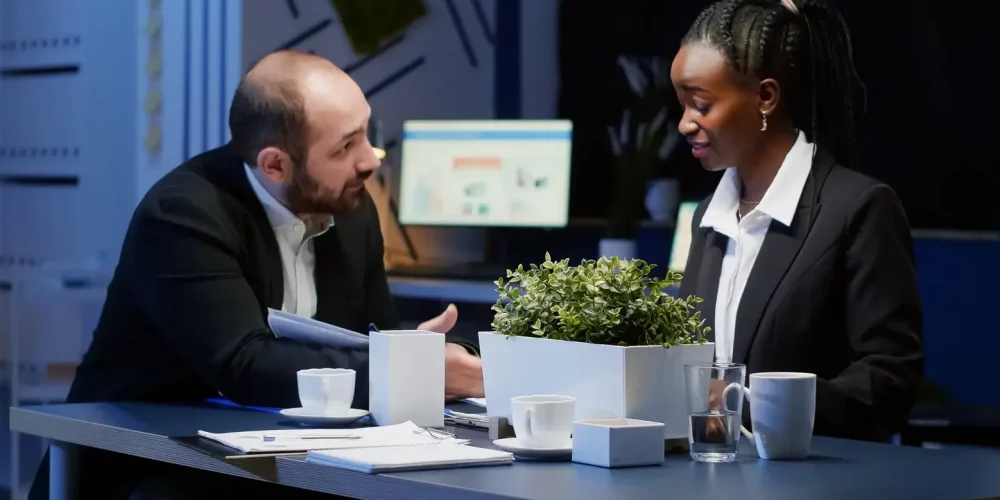 A man and a woman sit together at a desk