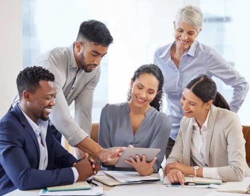 group of people looking at tablet business coaching