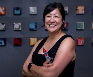 Executive Coach Summer Koide stands with arms crossed