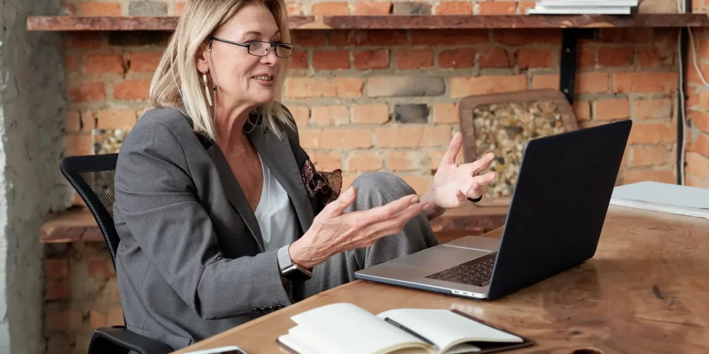 Woman on video conference taking about why a coaching credential matters.